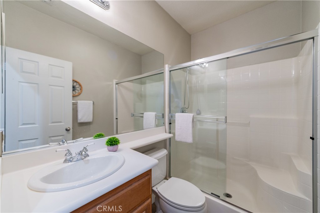 14236 Pointer Loop Eastvale, CA 92880 - Photo 16 of 38 a bathroom with a sink toilet and shower