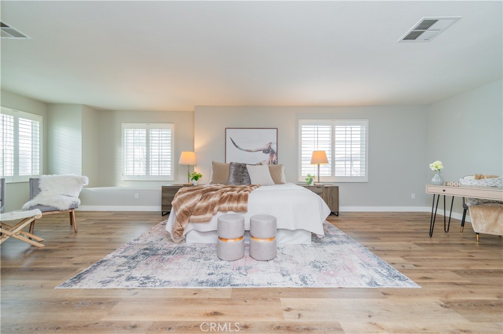 14236 Pointer Loop Eastvale, CA 92880 - Photo 20 of 38 a bedroom with a bed and a chair