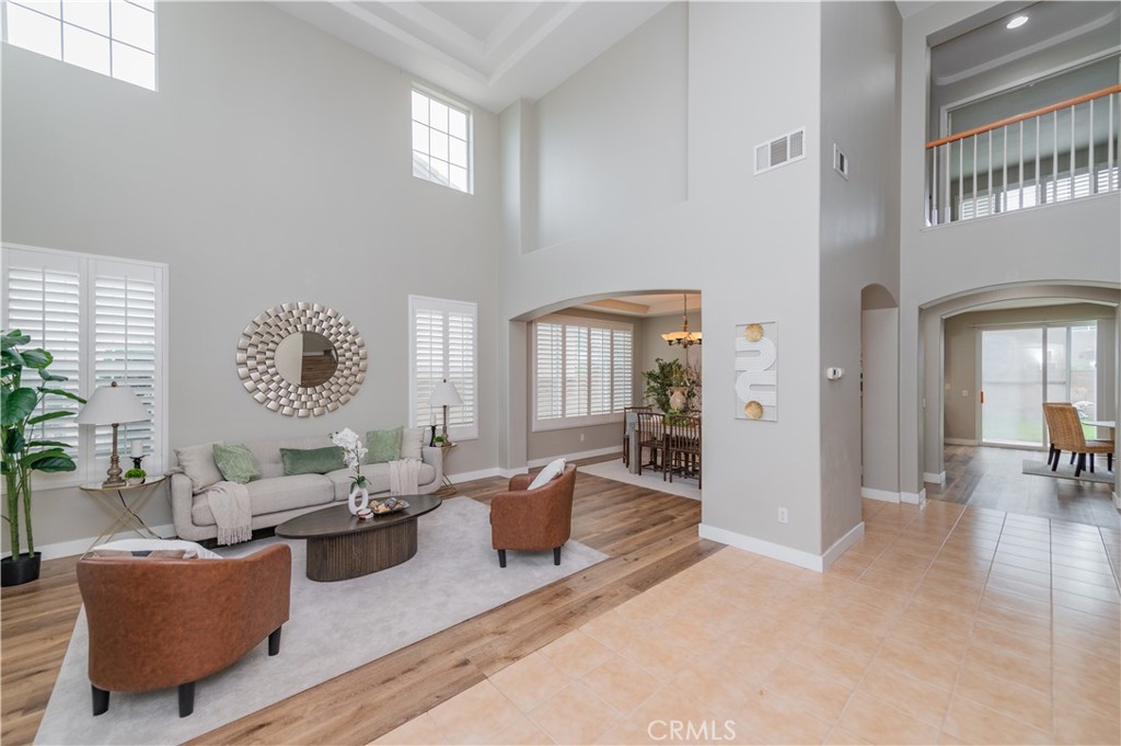 14236 Pointer Loop Eastvale, CA 92880 - Photo 2 of 38 a living room with furniture and a table