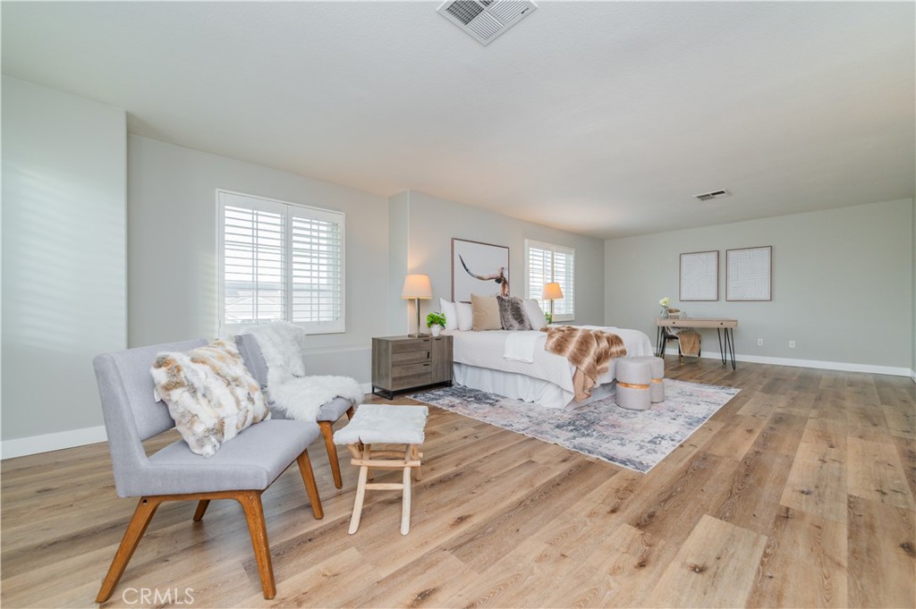 14236 Pointer Loop Eastvale, CA 92880 - Photo 21 of 38 a living room with furniture and a table