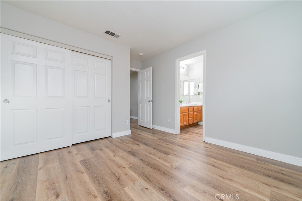 14236 Pointer Loop Eastvale, CA 92880 - Photo 24 of 38 a view of an empty room with wooden floor and window