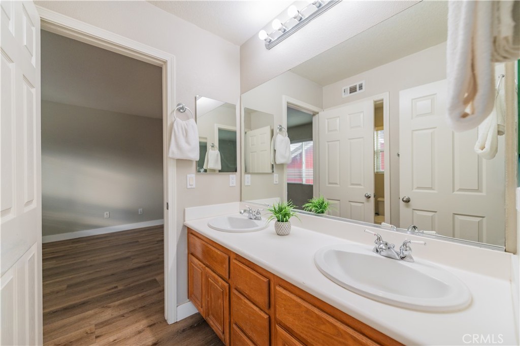 14236 Pointer Loop Eastvale, CA 92880 - Photo 26 of 38 a bathroom with a sink and a mirror