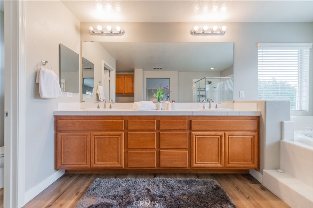 14236 Pointer Loop Eastvale, CA 92880 - Photo 29 of 38 a bathroom with a sink and a mirror