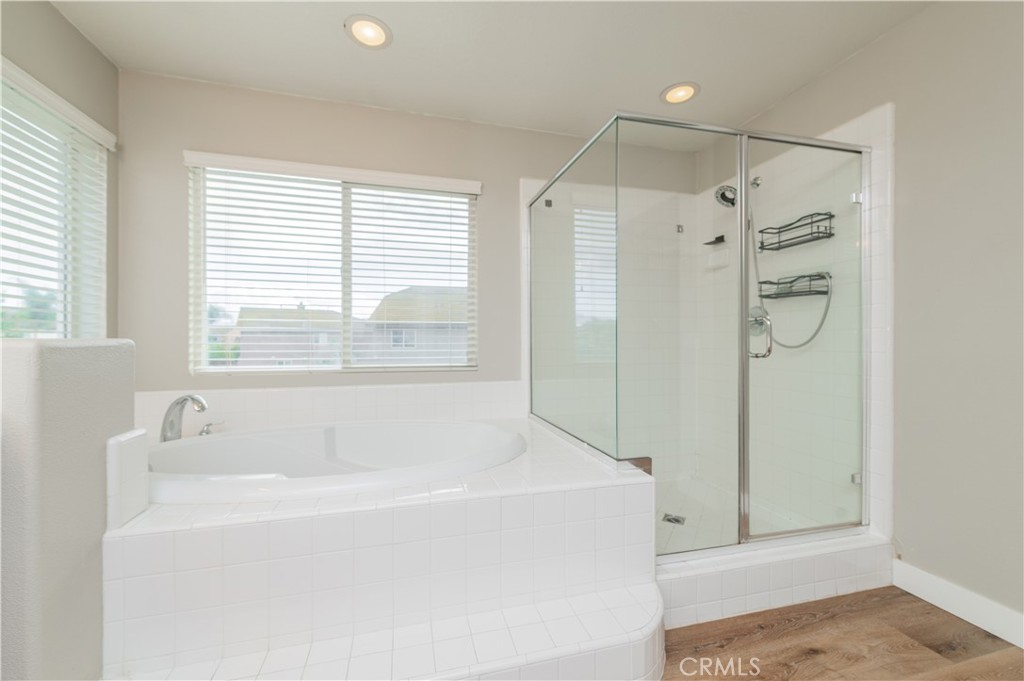 14236 Pointer Loop Eastvale, CA 92880 - Photo 30 of 38 a bathroom with a bathtub and a shower