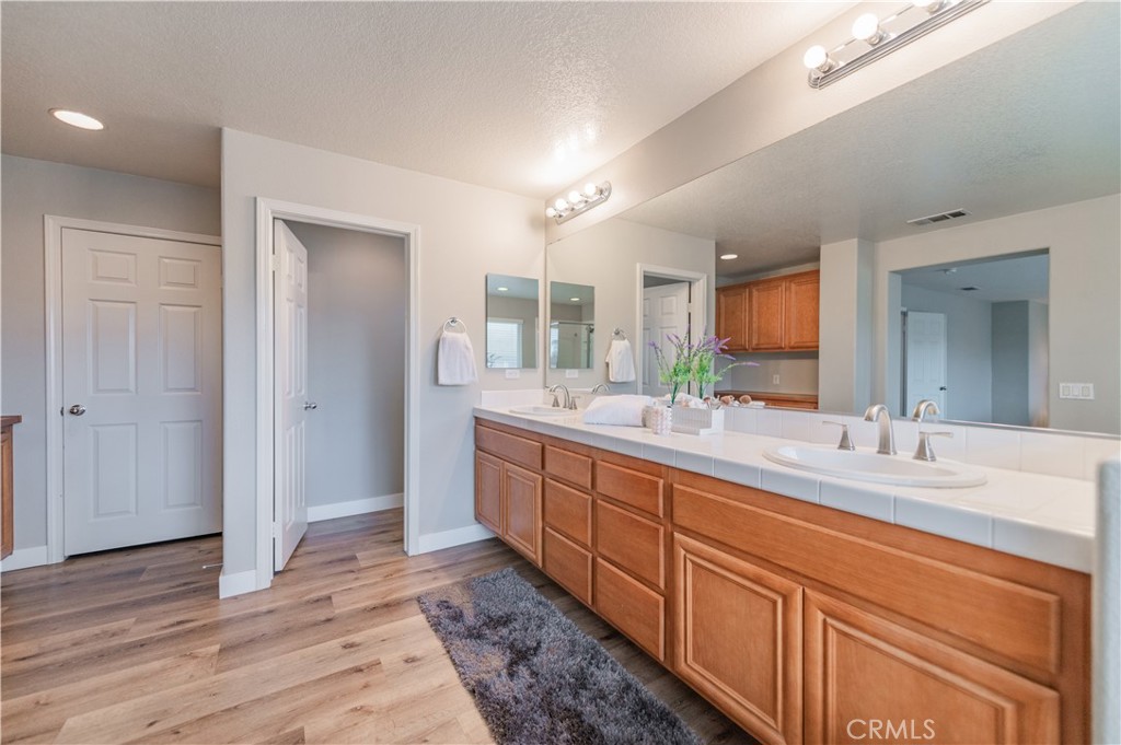 14236 Pointer Loop Eastvale, CA 92880 - Photo 31 of 38 a large bathroom with double vanity and mirrors