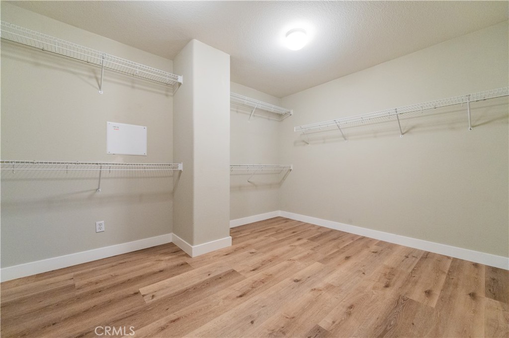 14236 Pointer Loop Eastvale, CA 92880 - Photo 32 of 38 a view of empty room with wooden floor