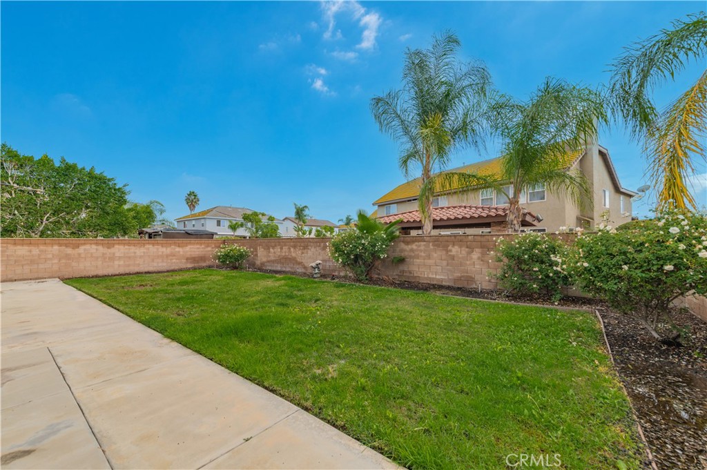 14236 Pointer Loop Eastvale, CA 92880 - Photo 33 of 38 a view of a garden with a house
