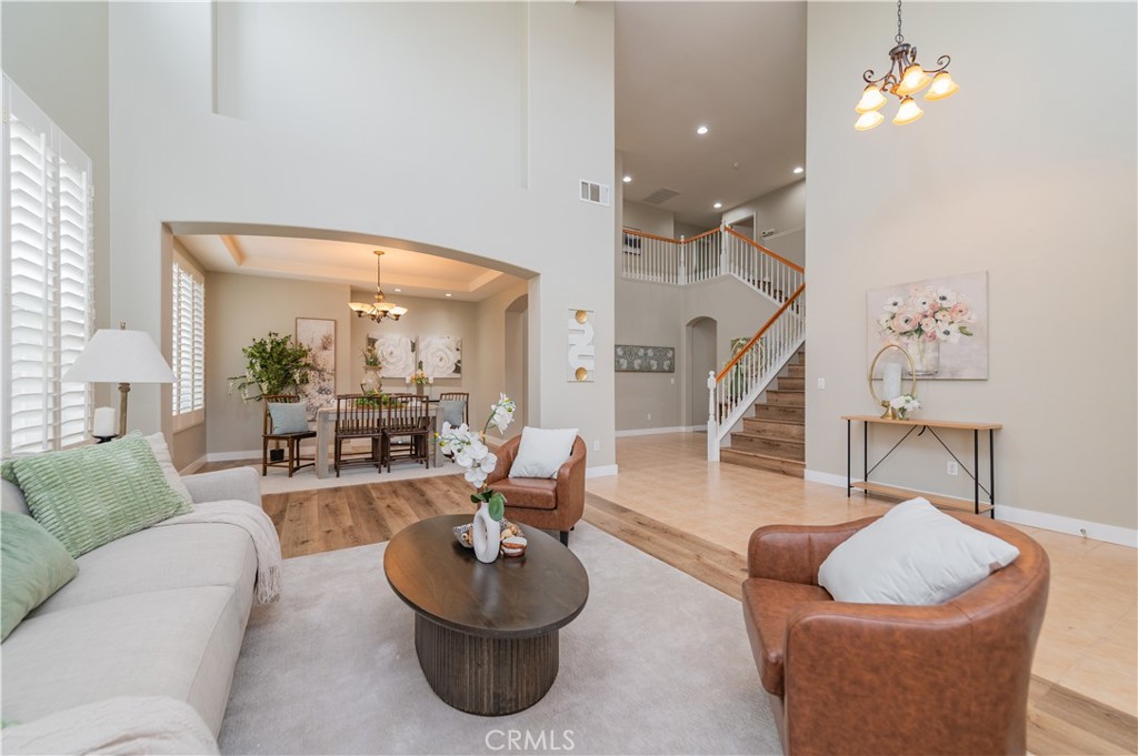 14236 Pointer Loop Eastvale, CA 92880 - Photo 4 of 38 a living room with furniture and a wooden floor
