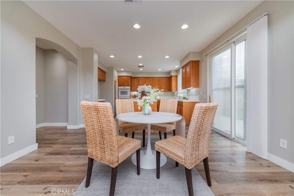 14236 Pointer Loop Eastvale, CA 92880 - Photo 8 of 38 a view of a dining room with furniture and wooden floor