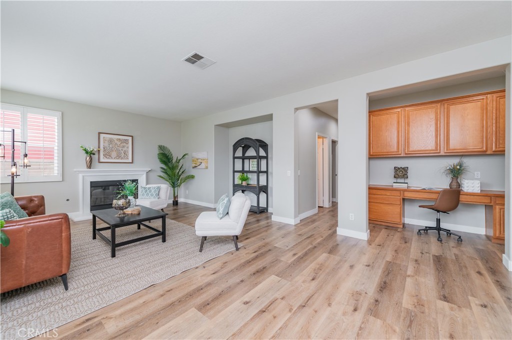 14236 Pointer Loop Eastvale, CA 92880 - Photo 9 of 38 a living room with furniture or couch and a wooden floor