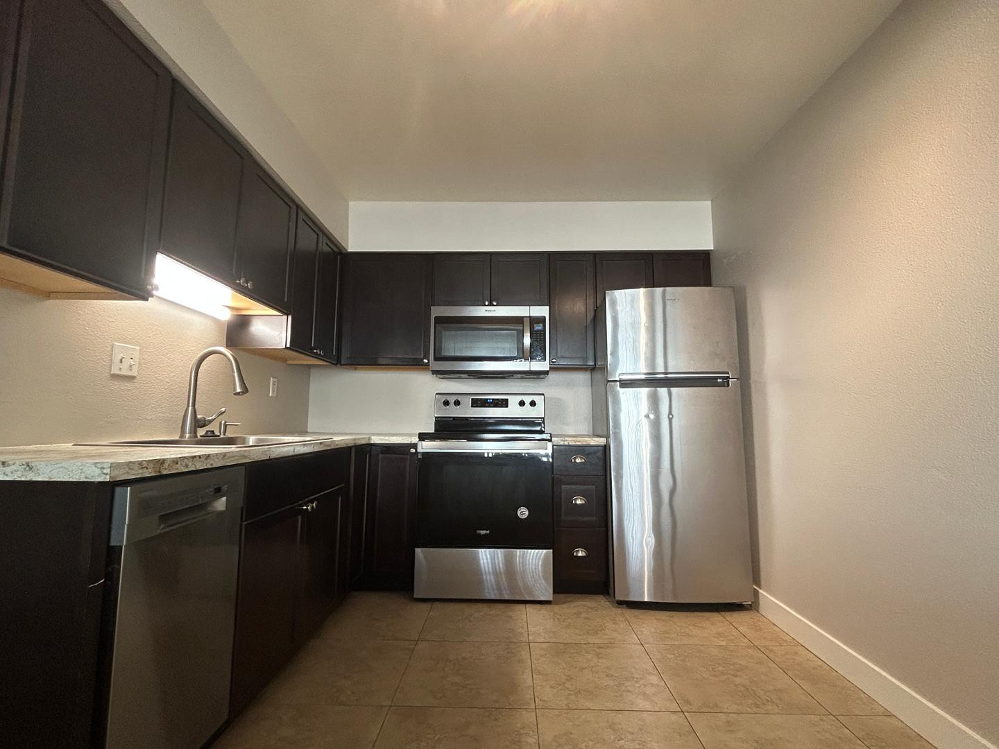 859 South Ext Road Mesa, AZ 85210 - Photo 19 of 19 a kitchen with stainless steel appliances granite countertop a refrigerator and a sink