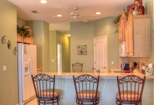 a kitchen with cabinets appliances a sink and a counter top space