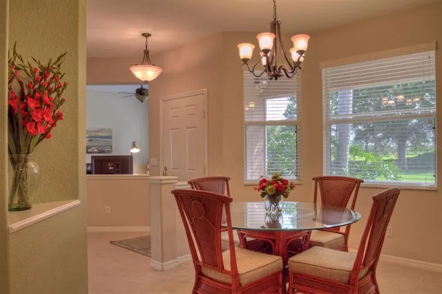 a view of a dining room with furniture wooden floor and a chandelier