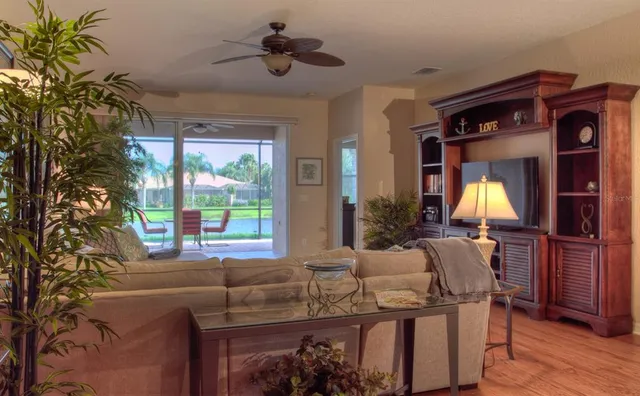 a view of a a dining room with furniture window and wooden floor