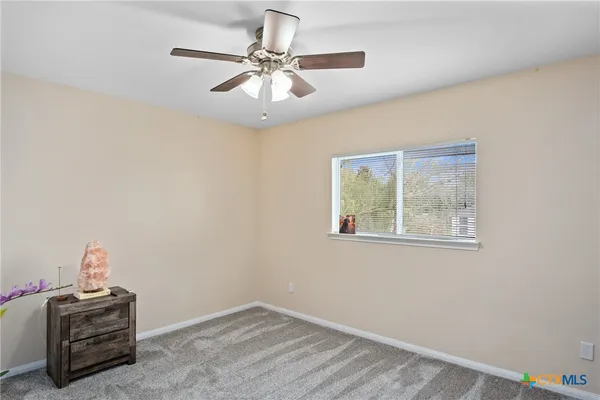 a view of room with hardwood floor and ceiling fan