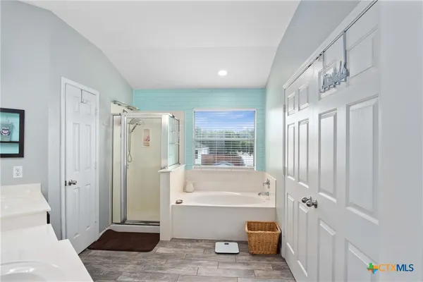 a bathroom with a tub a toilet and a shower