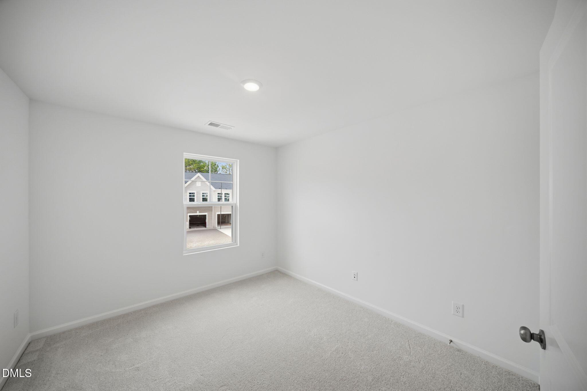 123 Tree Moss Court Rolesville, NC 27571 - Photo 19 of 33 a view of an empty room with a window