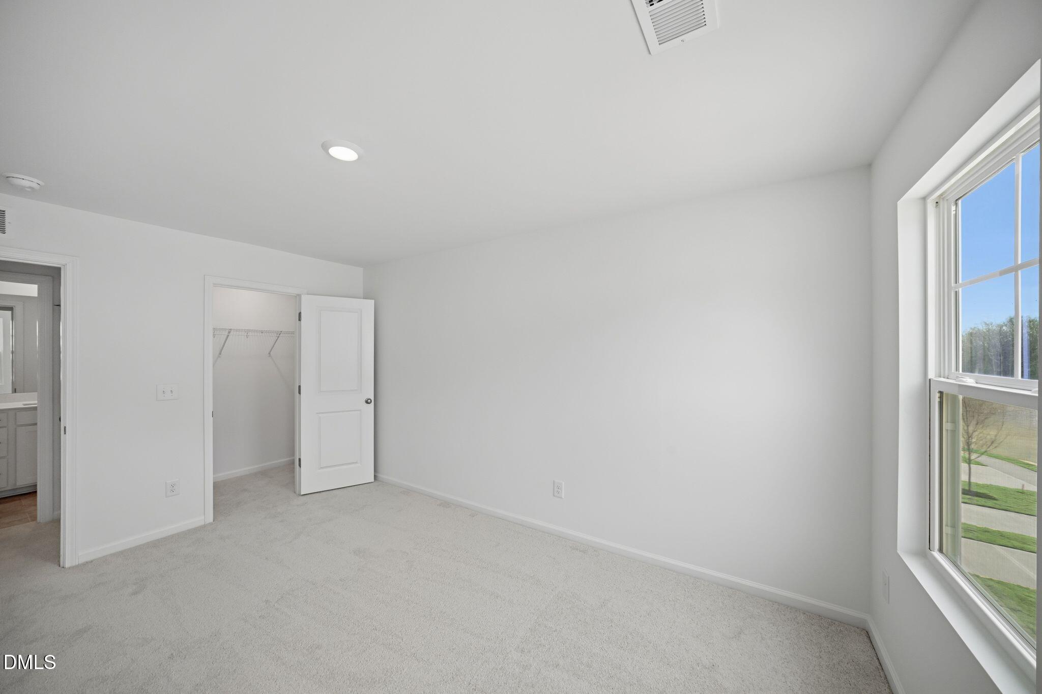 123 Tree Moss Court Rolesville, NC 27571 - Photo 20 of 33 an empty room with windows