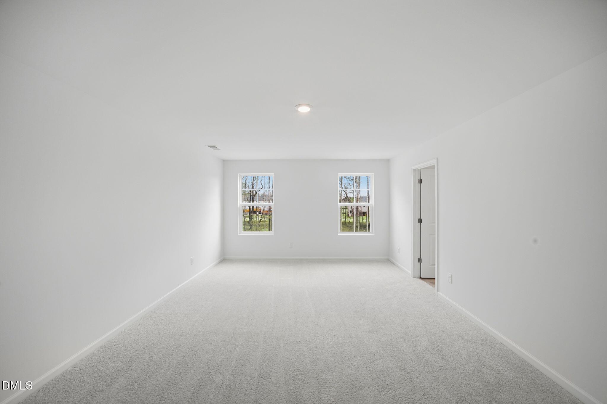 123 Tree Moss Court Rolesville, NC 27571 - Photo 26 of 33 a view of a big room with windows and chandelier fan