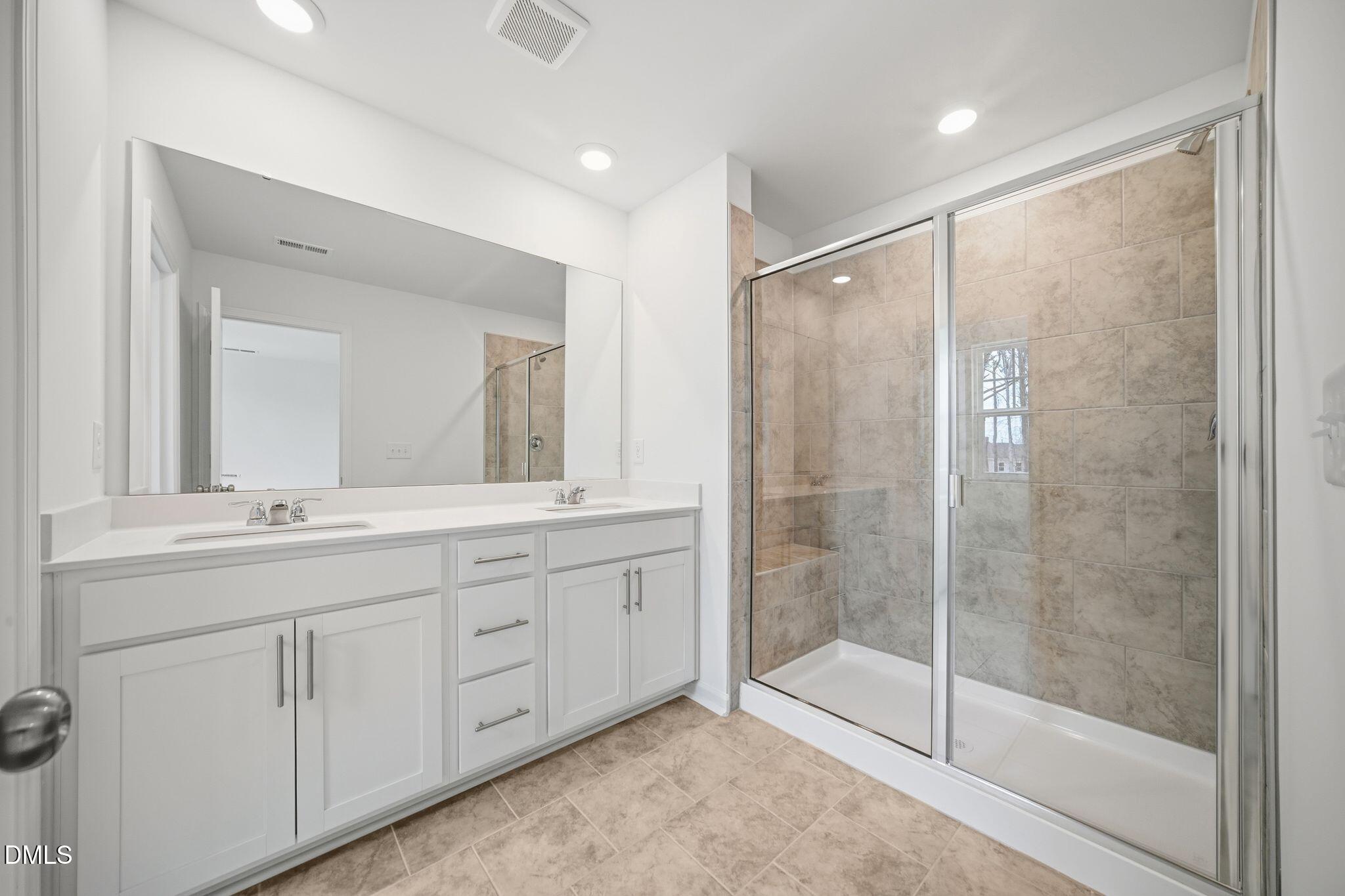 123 Tree Moss Court Rolesville, NC 27571 - Photo 28 of 33 a bathroom with double sink and a mirror