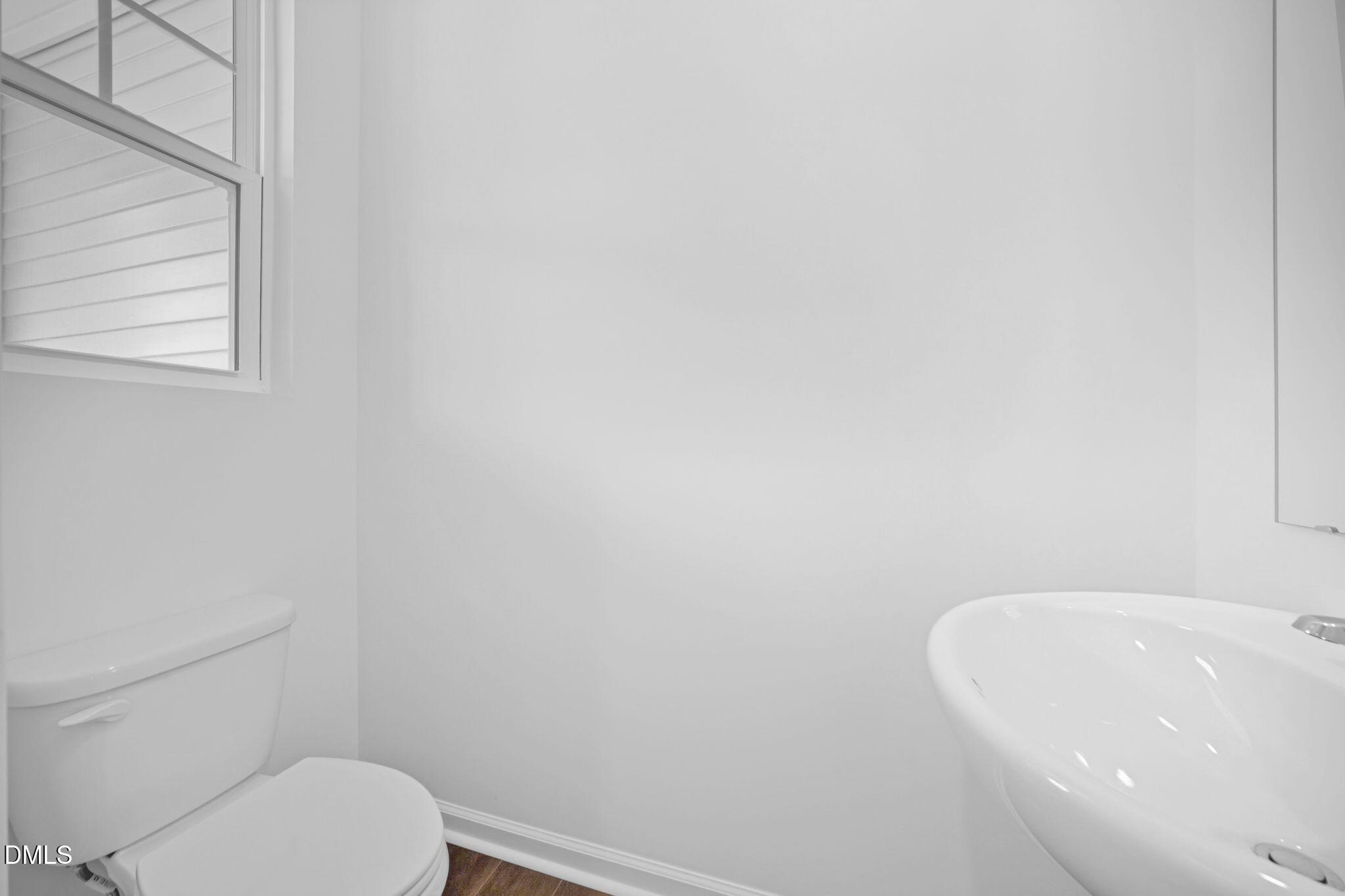 123 Tree Moss Court Rolesville, NC 27571 - Photo 30 of 33 a white toilet sitting next to a white sink