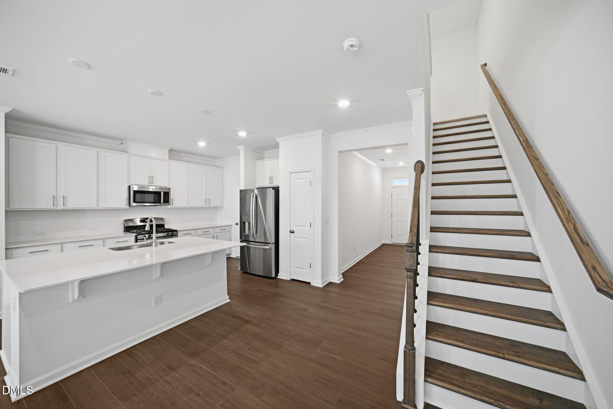 123 Tree Moss Court Rolesville, NC 27571 - Photo 3 of 33 a kitchen with stainless steel appliances a refrigerator and a sink