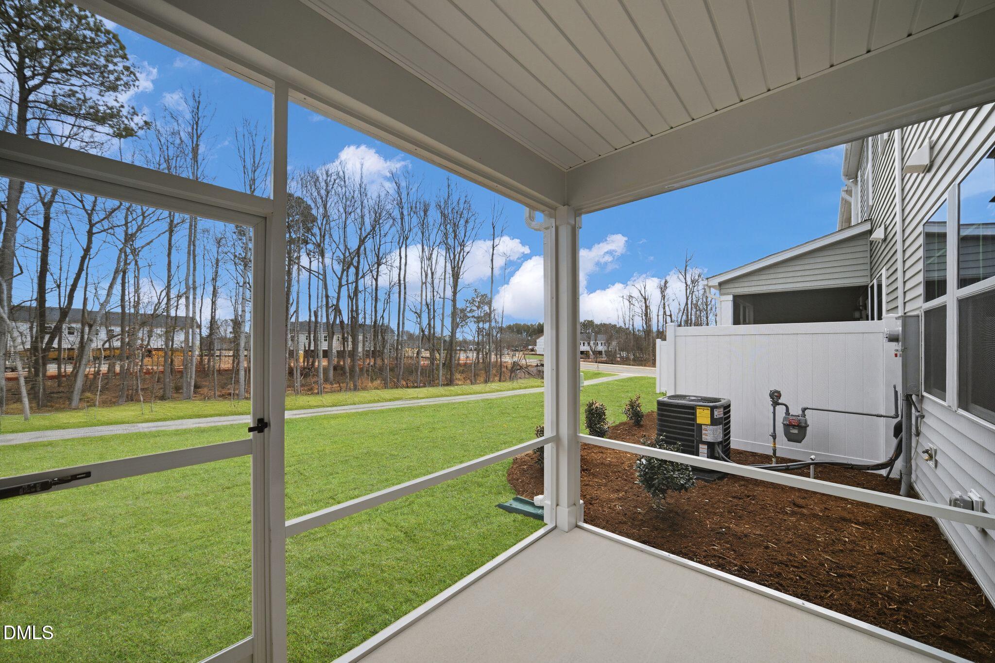 123 Tree Moss Court Rolesville, NC 27571 - Photo 32 of 33 a view of a porch and garden