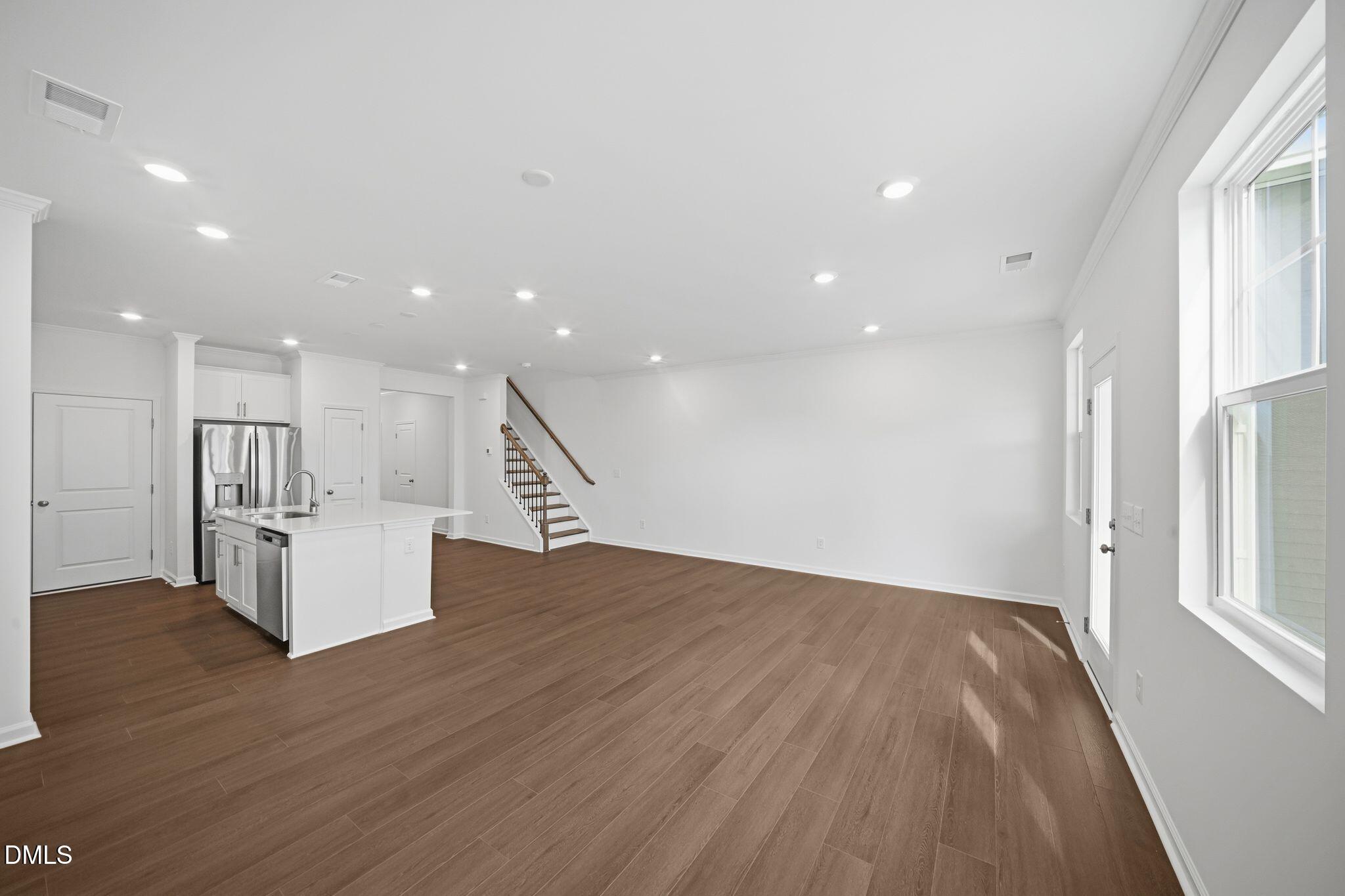 123 Tree Moss Court Rolesville, NC 27571 - Photo 6 of 33 a view of empty room with wooden floor and windows