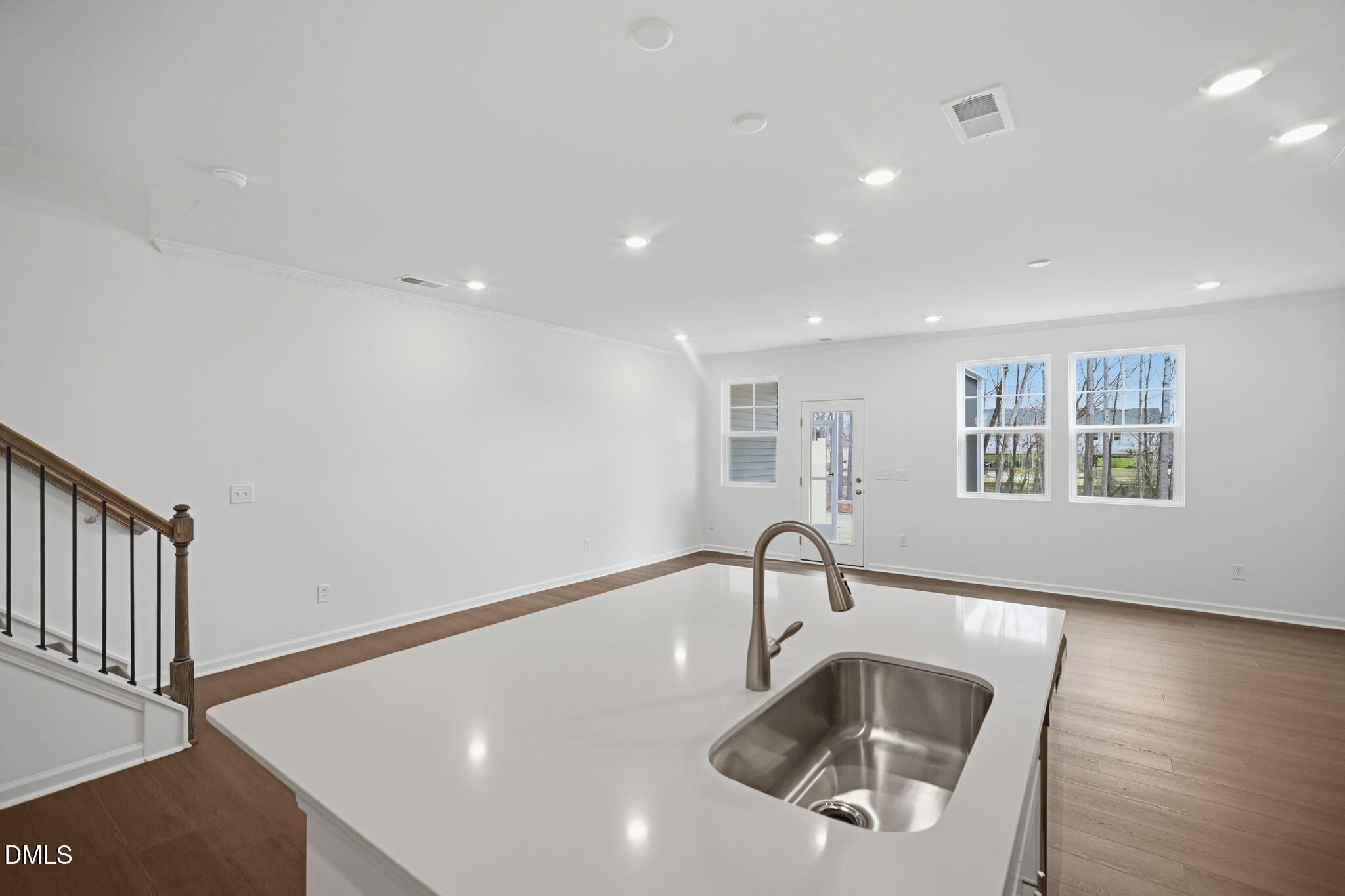 123 Tree Moss Court Rolesville, NC 27571 - Photo 7 of 33 a kitchen with granite countertop a sink and a wooden floor