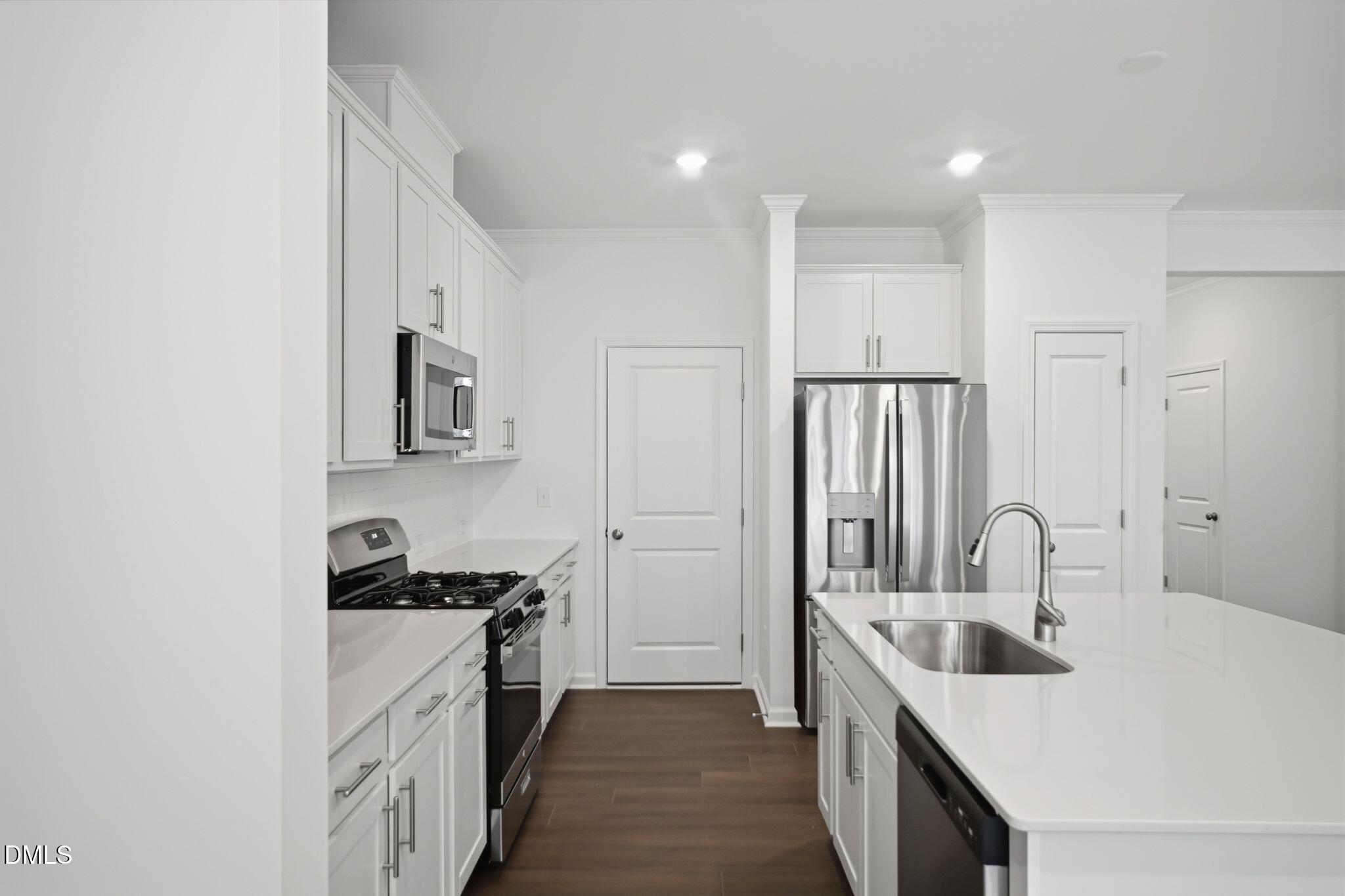 123 Tree Moss Court Rolesville, NC 27571 - Photo 8 of 33 a kitchen with stainless steel appliances granite countertop a sink stove and refrigerator