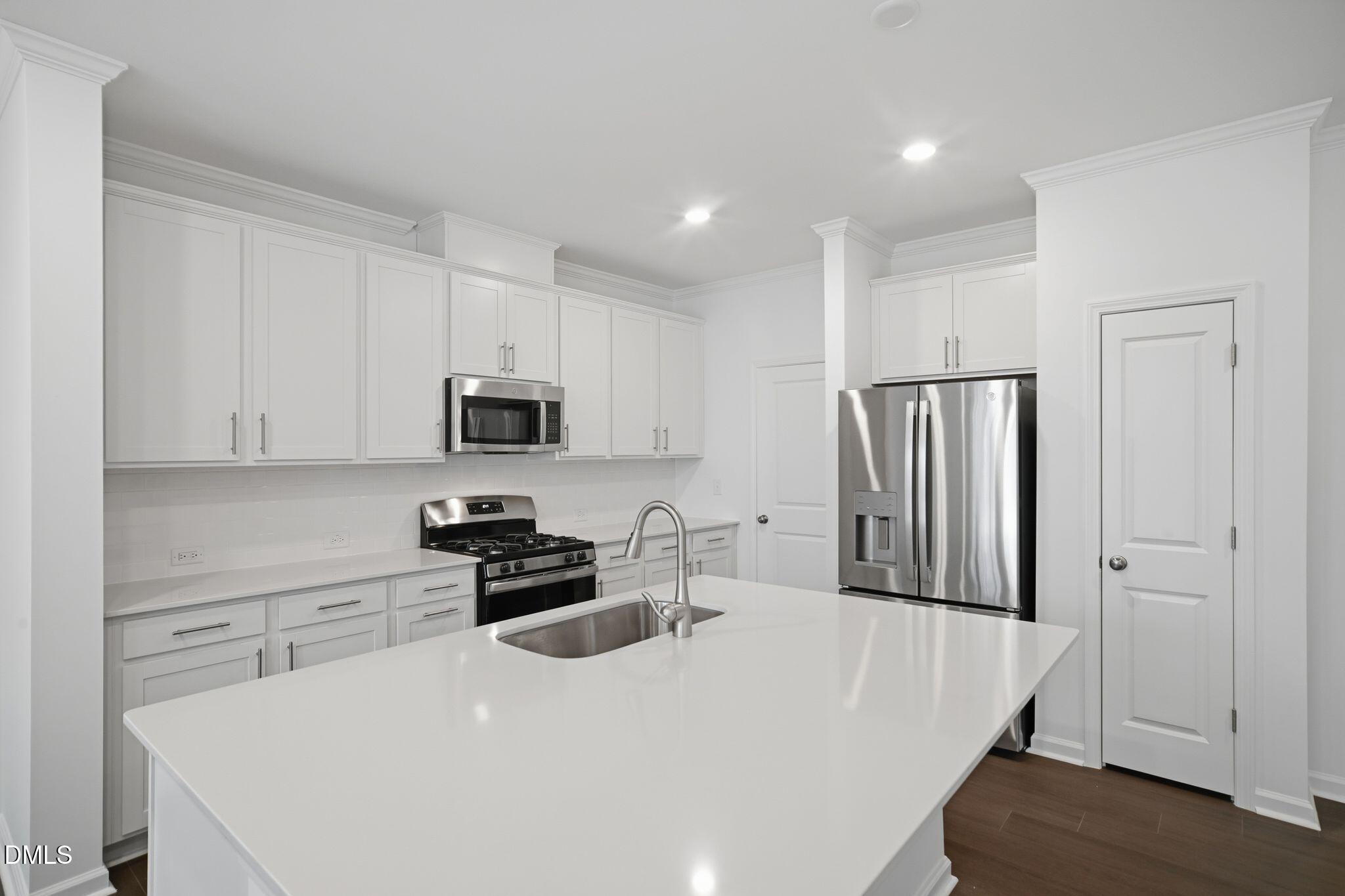 123 Tree Moss Court Rolesville, NC 27571 - Photo 10 of 33 a kitchen with stainless steel appliances a refrigerator a stove a microwave and cabinets