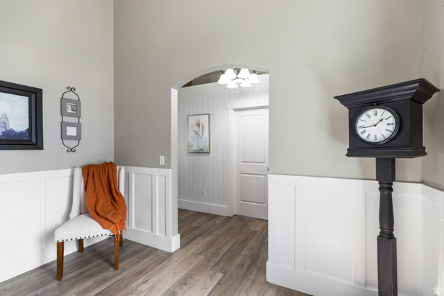 580 Cherry Ridge Lane Richmond, UT 84333 - Photo 4 of 53 Music room with a wainscoted wall, wood finished floors, a decorative wall, suspended lighting, and arched walkways