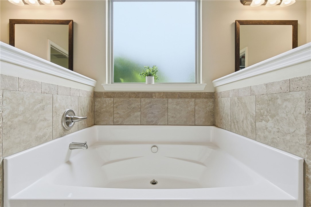138 Buckland Drive Anderson, SC 29621 - Photo 26 of 49 Relax in this inviting tub, featuring elegant tile and a serene frosted window.