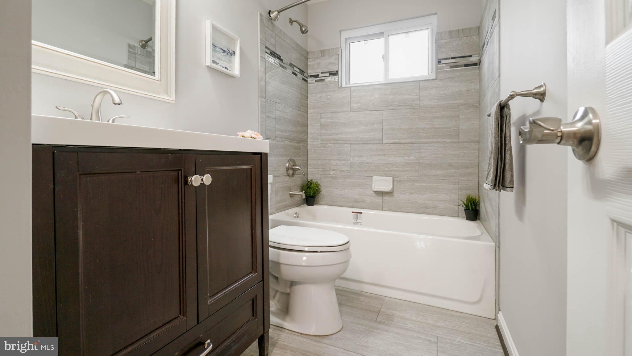 220 Atlanta Road Pasadena, MD 21122 - Photo 20 of 30 Newly renovated bathroom with ceramic tile