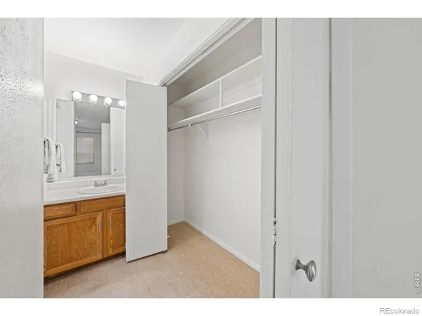 a bathroom with a sink shower and a mirror