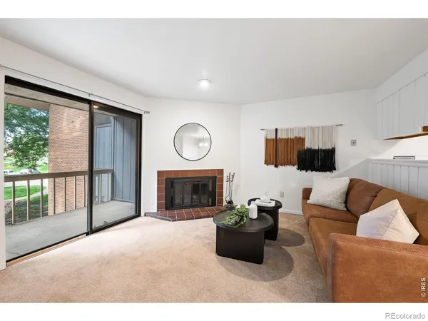 a living room with furniture a large window and a flat screen tv