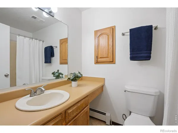 a view of hallway with bathroom and mirror