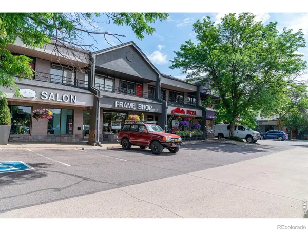 a view of a building with cars parked