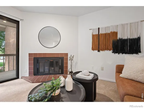 a view of a livingroom with furniture and a fireplace
