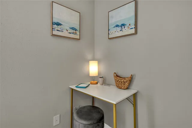 a bedroom with a table and a lamp