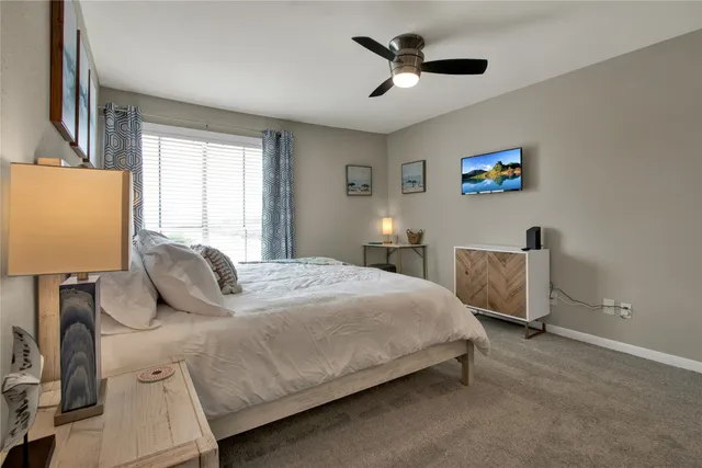 a bedroom with a bed and a lamp