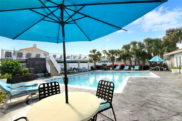 a view of a chairs and table on the deck