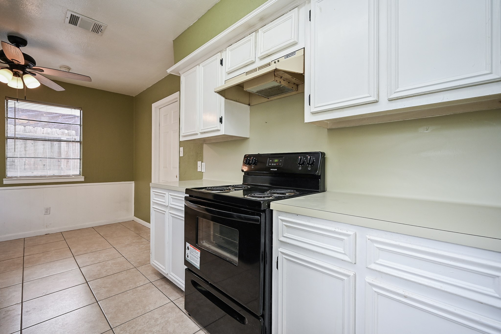 6634 Bridgegate Drive Spring, TX 77373 - Photo 8 of 16 a kitchen with stainless steel appliances granite countertop a stove and a white cabinets