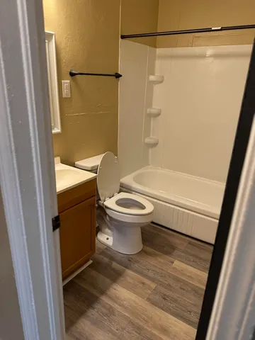 a bathroom with a toilet and a shower