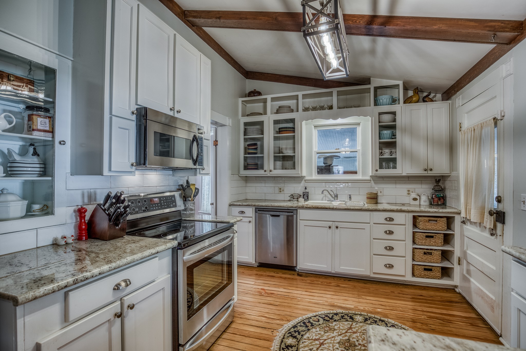 235 Hickory Road New Ulm, TX 78950 - Photo 16 of 43 a kitchen with stainless steel appliances granite countertop a stove sink and cabinets