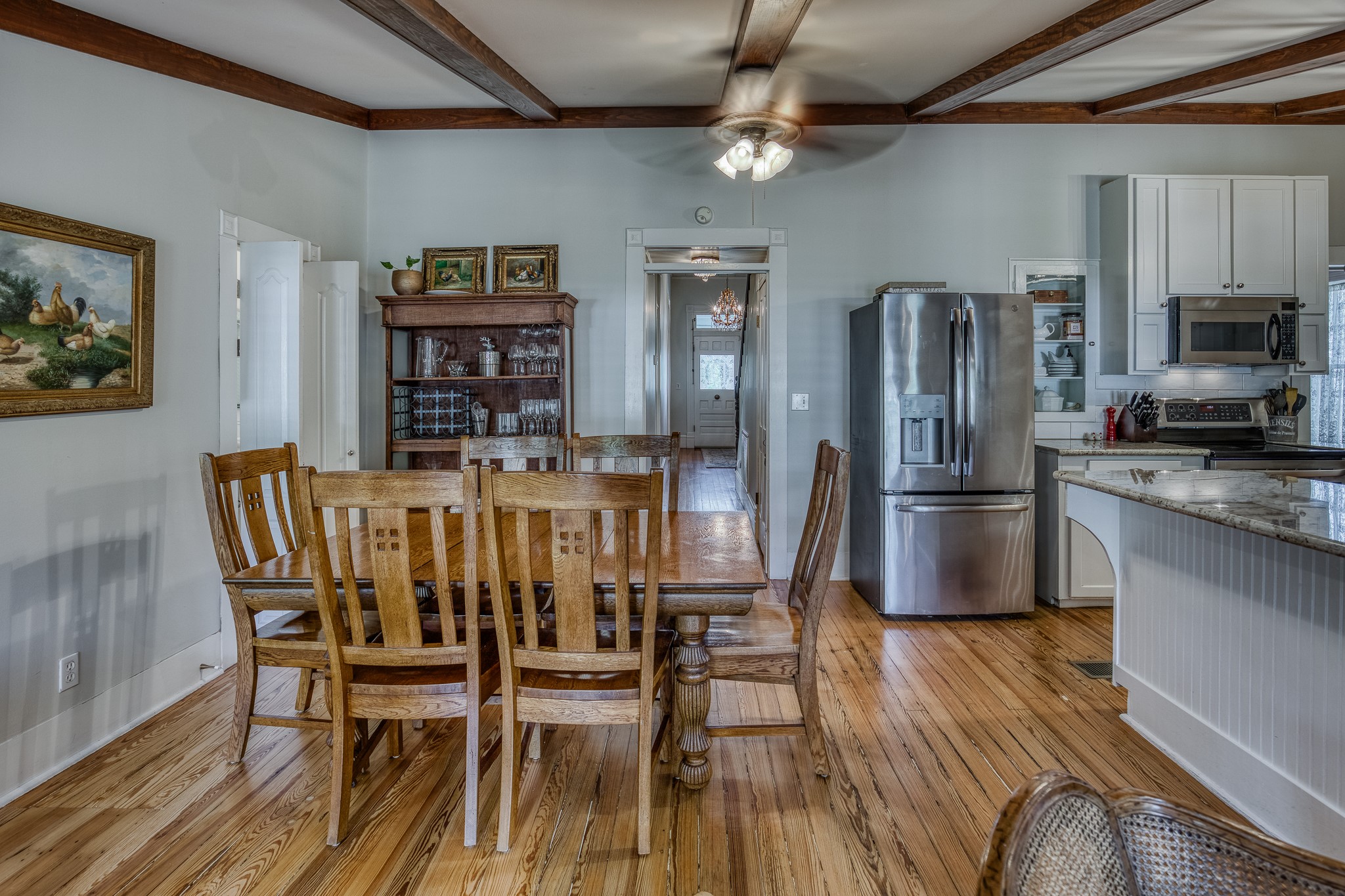 235 Hickory Road New Ulm, TX 78950 - Photo 19 of 43 a dining room with stainless steel appliances kitchen island granite countertop a dining table chairs and a refrigerator