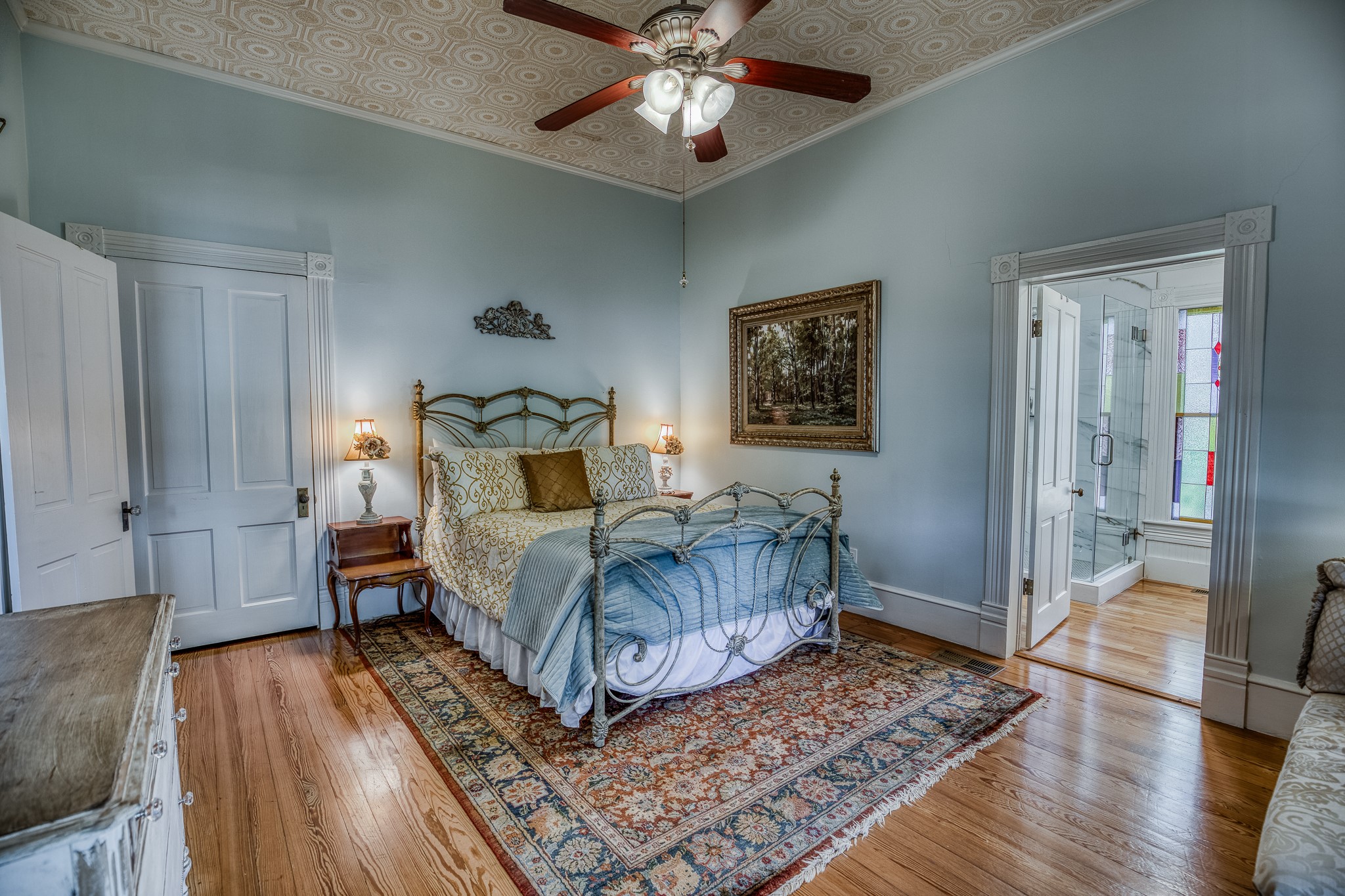 235 Hickory Road New Ulm, TX 78950 - Photo 27 of 43 a bedroom with a bed and a chandelier