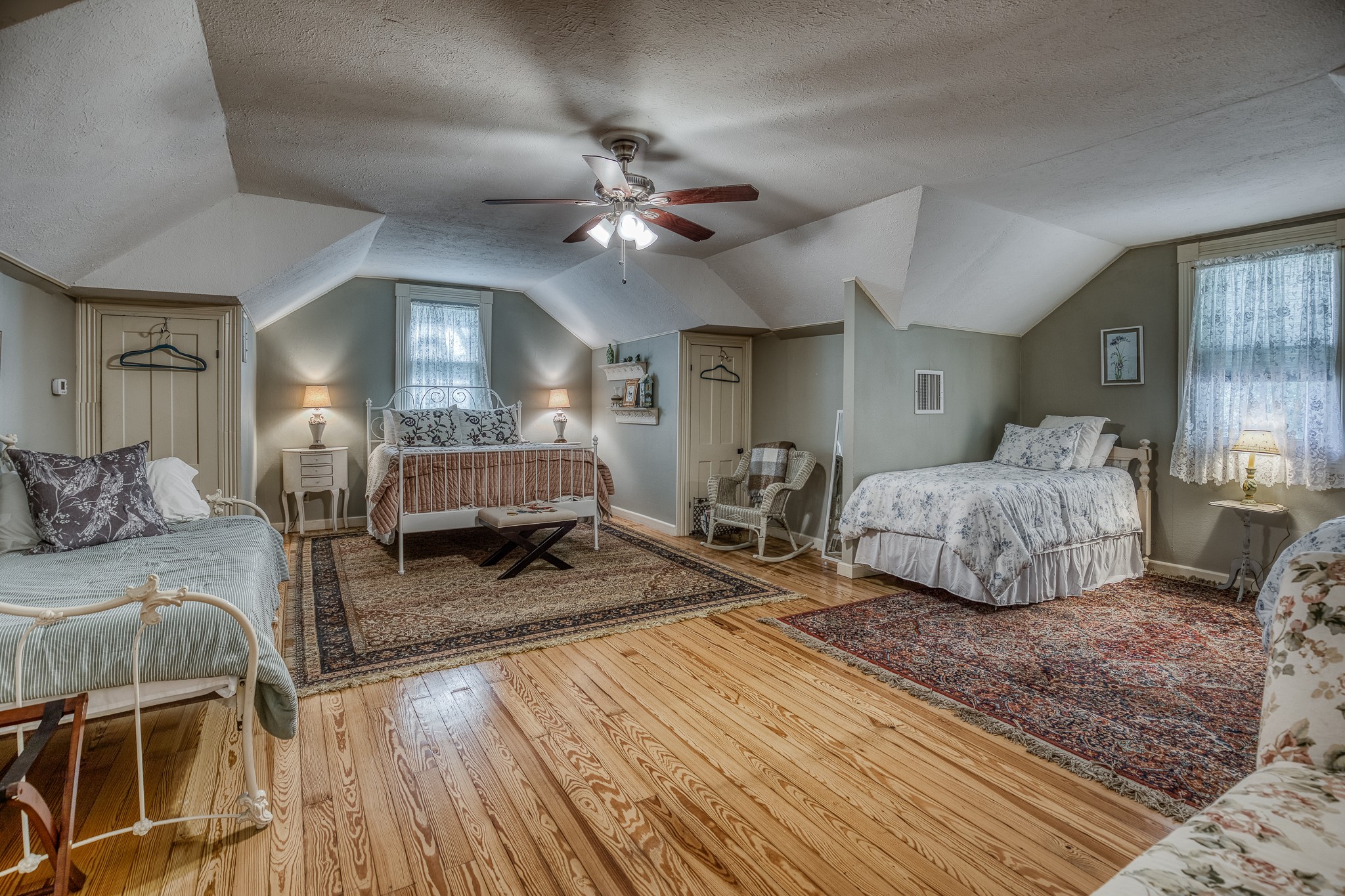 235 Hickory Road New Ulm, TX 78950 - Photo 33 of 43 a spacious bedroom with a bed a chandelier and couch