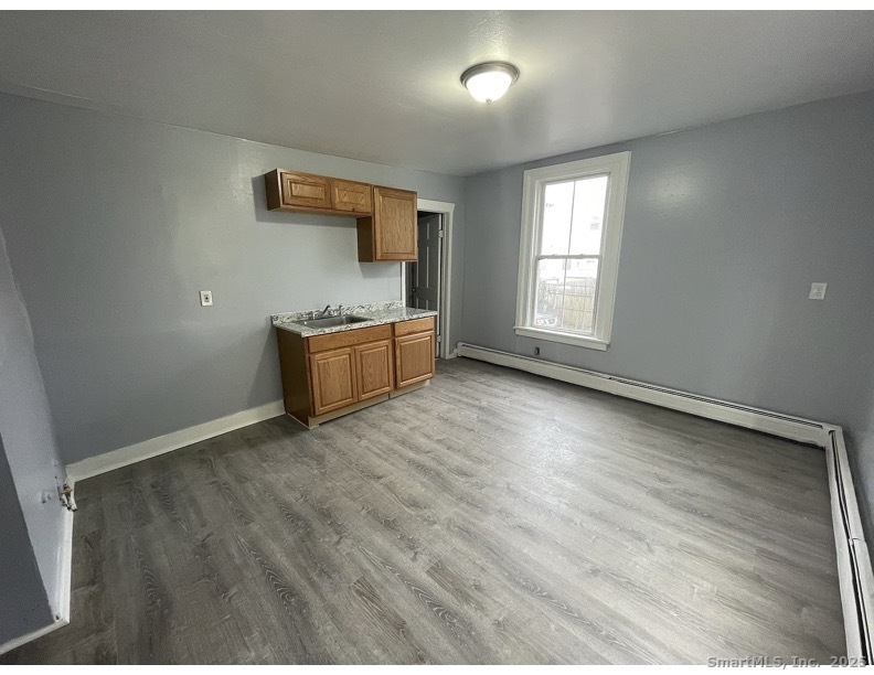34 Park Street, Unit 1 Bridgeport, CT 06608 - Photo 1 of 8 an empty room with windows