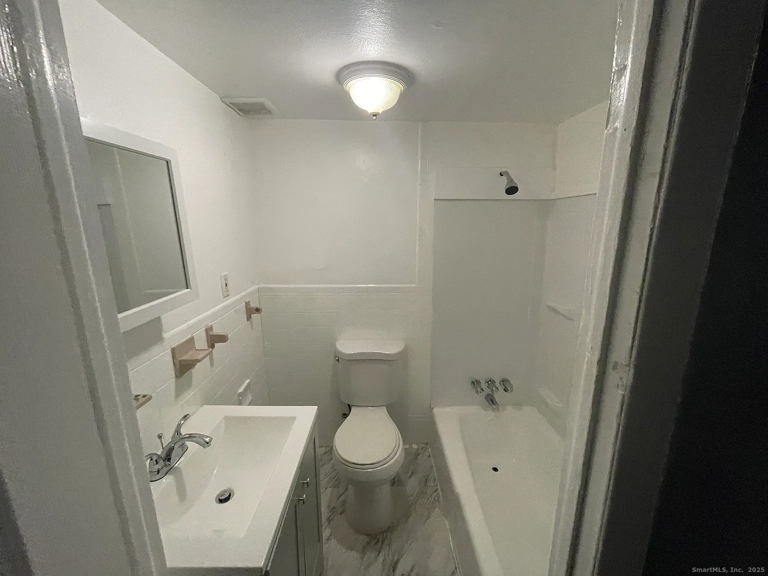 34 Park Street, Unit 1 Bridgeport, CT 06608 - Photo 2 of 8 a bathroom with a sink a toilet and shower